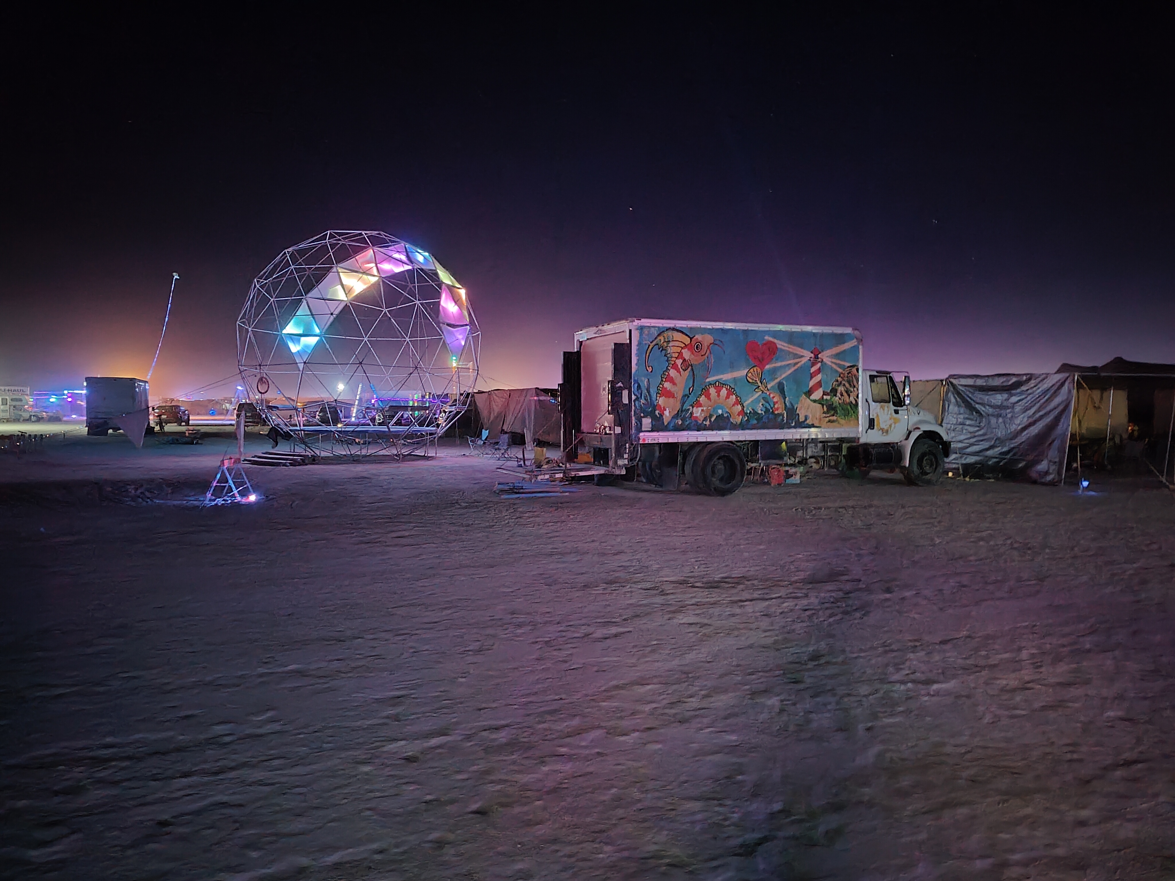 Sphere at night with truck